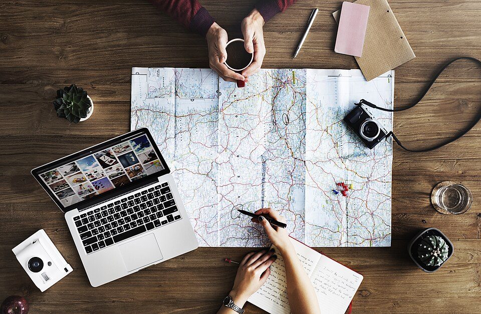 Planning a trip over coffee (Unsplash)